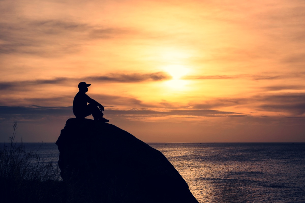 freepik-silhouette-man-sitting-on-big-rock-with-sightseeing-of-sunset-in-tropical-sea
